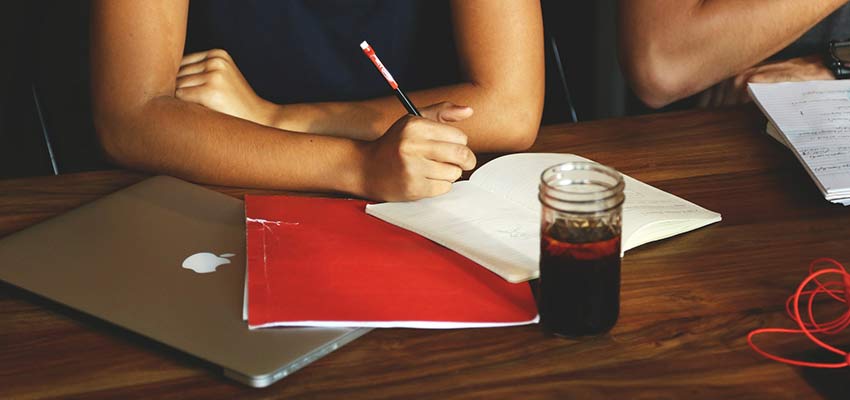 Woman taking notes in a meeting.