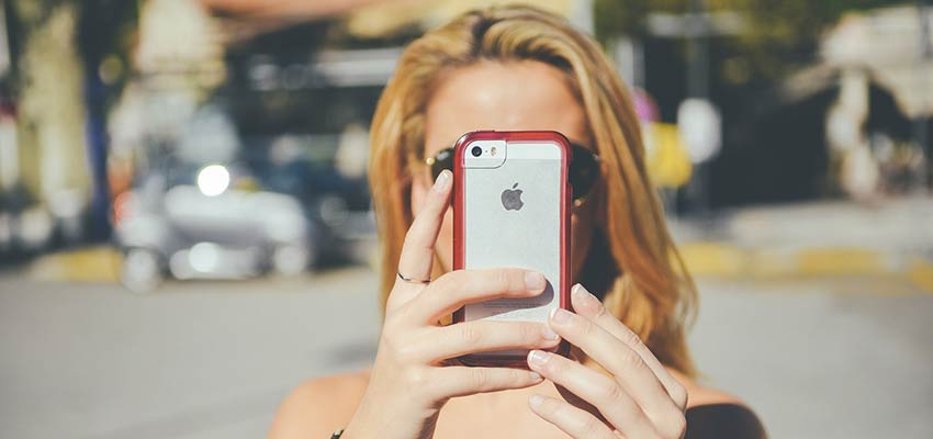 Woman looking at her iPhone screen.