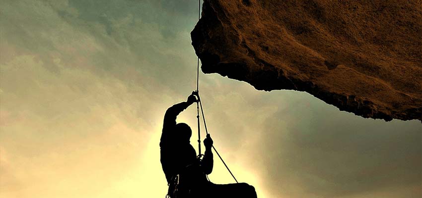 Man climbing a mountain