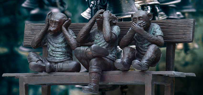 Plastic monkeys on a bench.