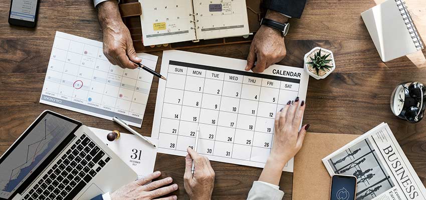 People viewing a calendar.
