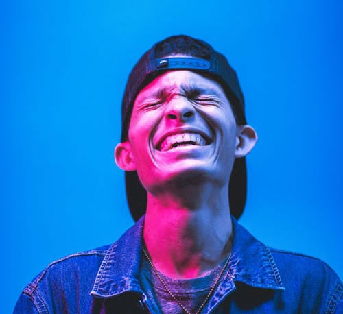 blue background man smiling