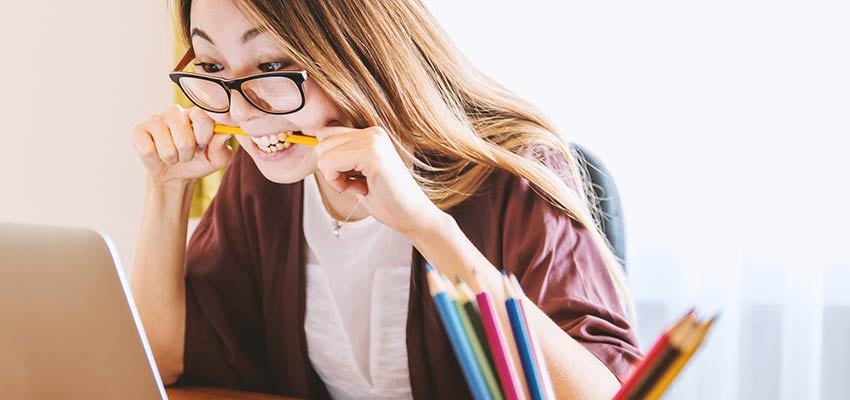 Frustrated woman looking at computer screen.