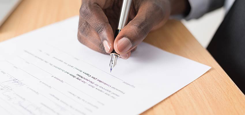 Man signing a document.