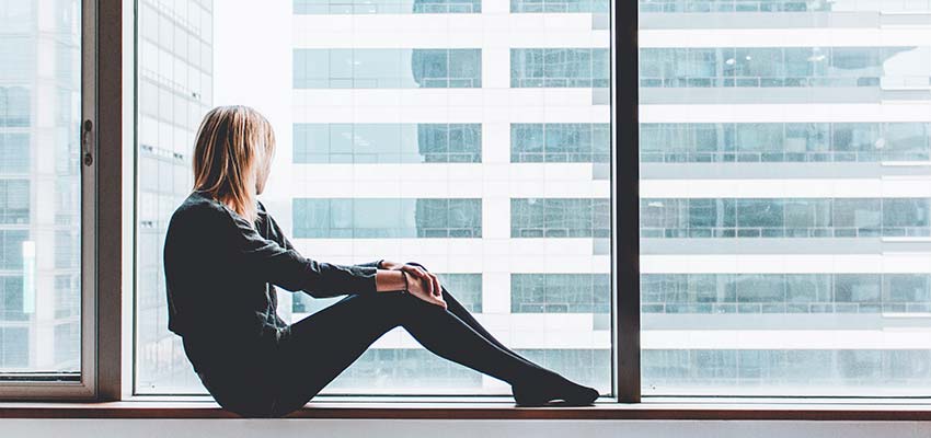Woman looking out a window.