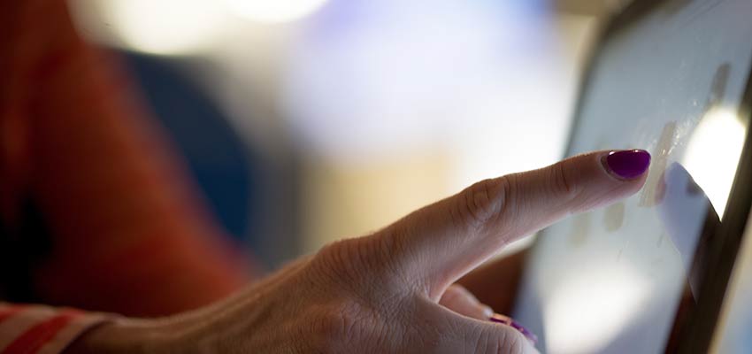 Person touching a tablet screen.