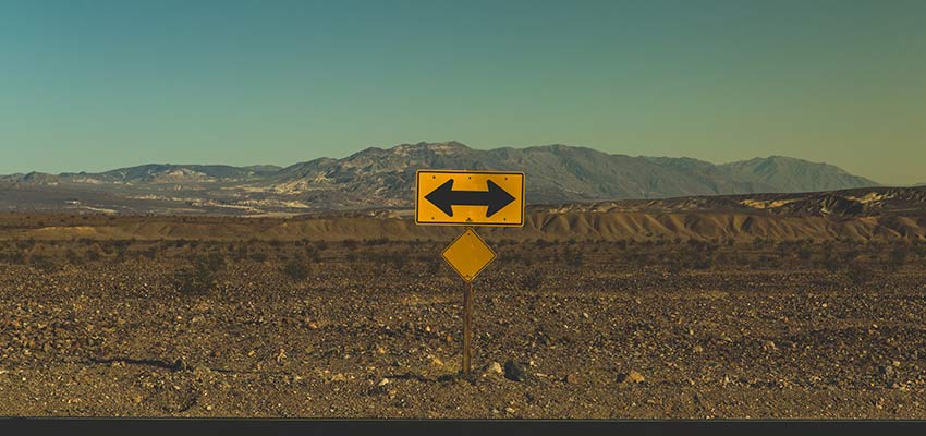Directional sign on a desolate road.