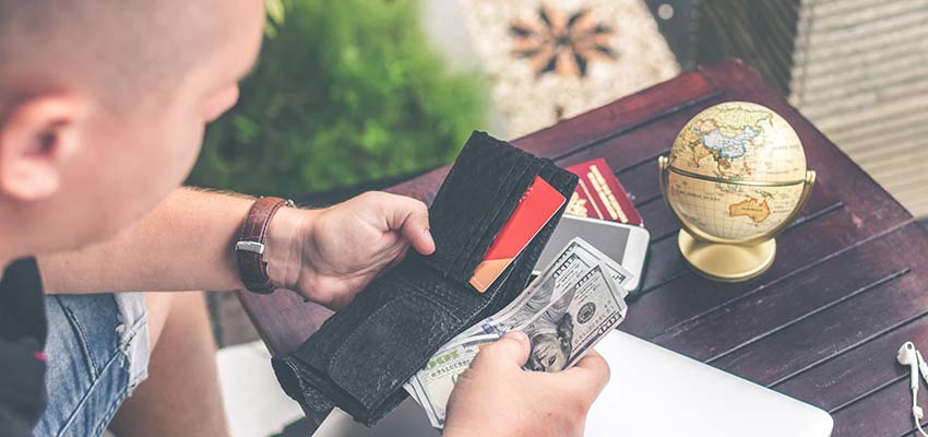 Man looking through his wallet.