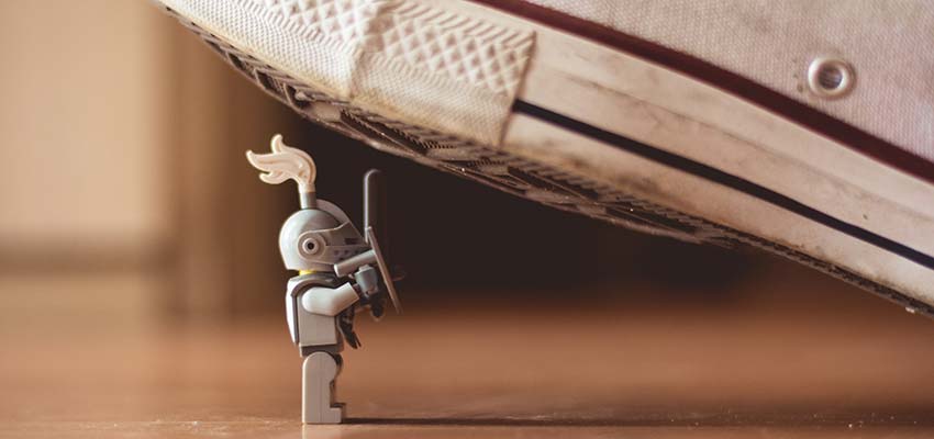 A toy positioned under a shoe.