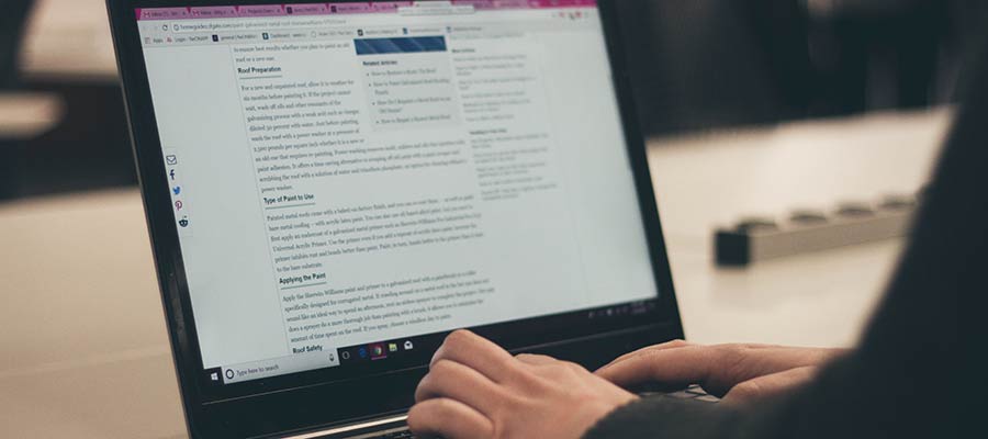 A person typing on a laptop computer.