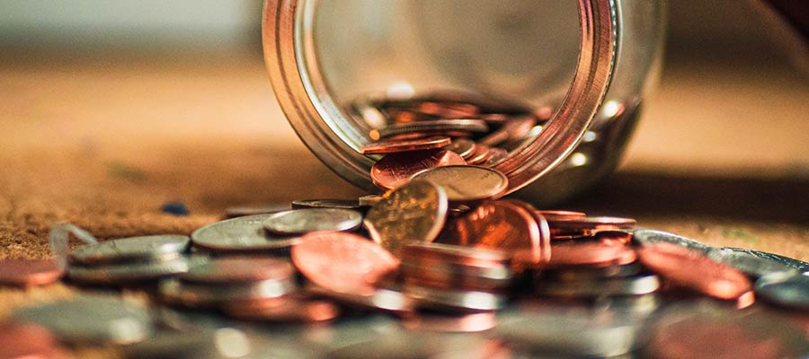 Coins spilling from a jar.