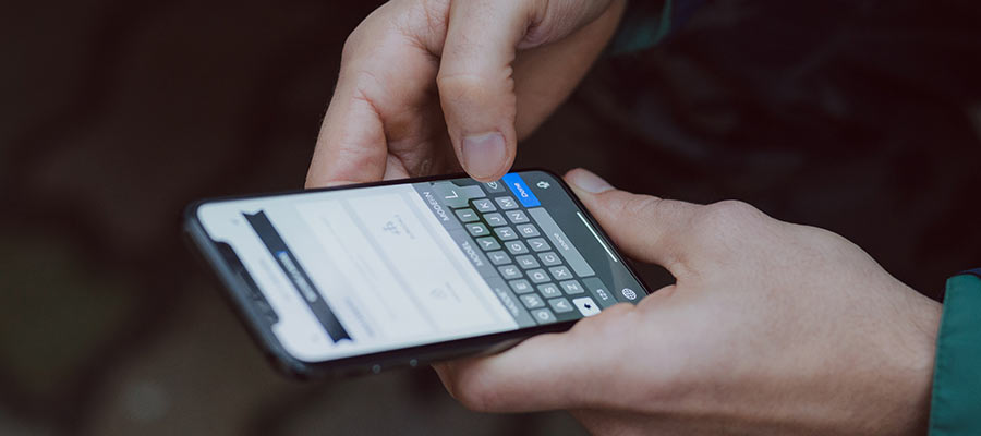 A person typing on a smartphone.
