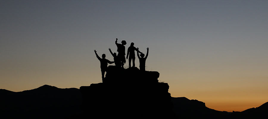 A group of people standing outdoors.