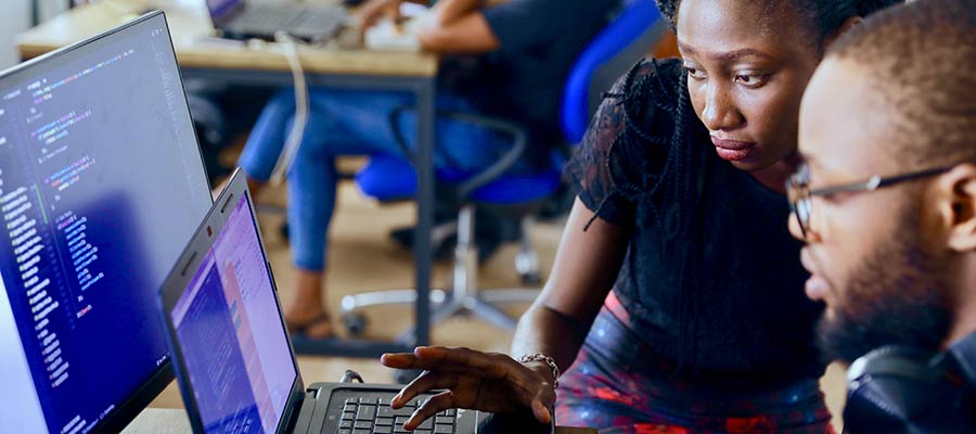 Two people looking at a computer.