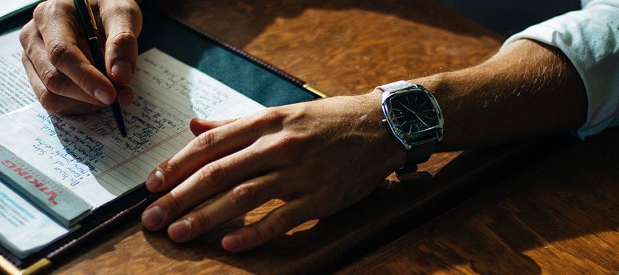 A person writing in a notebook.