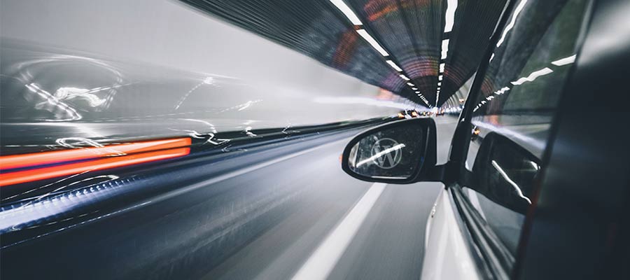 A car speeds through a tunnel.